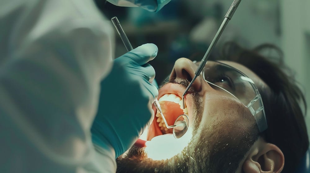 A dentist treating a patient's tooth during root canal treatment